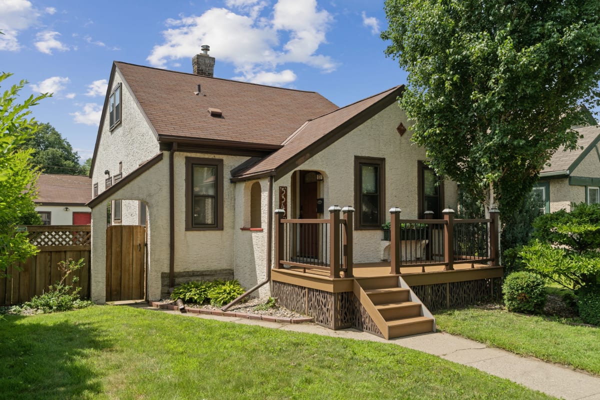 Charming residential property nestled in a quiet neighborhood, featuring a welcoming front porch.