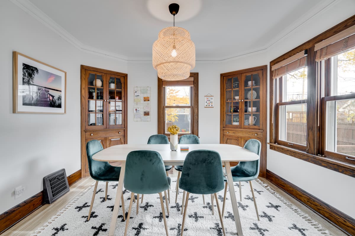 Gather around your elegant dining table beneath a stunning wicker pendant light, where meals become memories.