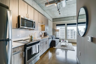 Interior of a contemporary apartment featuring a kitchen and living area.