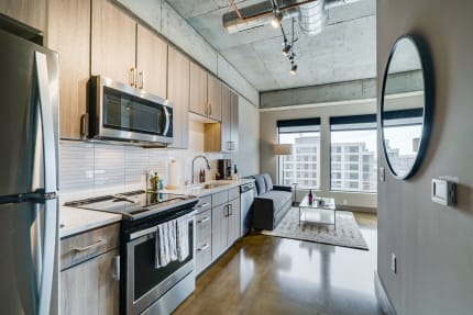 Interior of a contemporary apartment featuring a kitchen and living area.