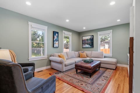 Cozy living room with gray walls, a sectional couch, and artwork.