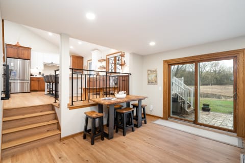Open-concept kitchen and dining area featuring wooden furniture and plenty of light.