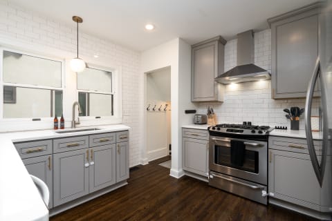 Stylish kitchen with gray cabinets and stainless steel appliances