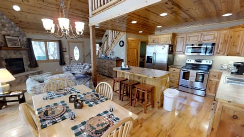 Interior view of a cozy kitchen and living space featuring wood elements and modern appliances.