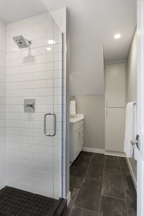 Modern bathroom with a glass shower and white vanity.
