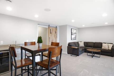 Modern open-plan living area with a sectional sofa and dining table.