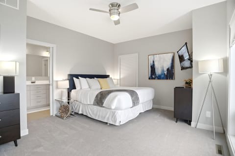 Modern bedroom featuring a plush bed, art, and cozy decor elements.