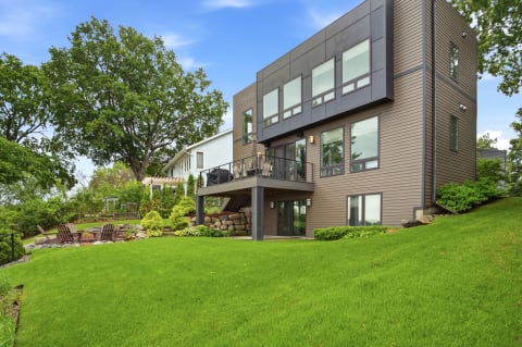 Contemporary vacation home on a hillside with a private balcony and landscaped gardens.