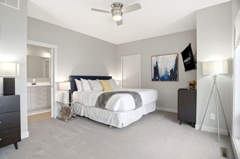 A tranquil bedroom with a plush bed, soft lighting, and modern accents creating a peaceful atmosphere.