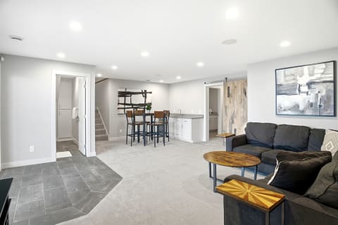 Cozy lower-level retreat featuring a lounge, dining area, and modern decor.