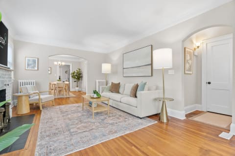Stylish and inviting living room with a light-colored sofa and wooden elements.