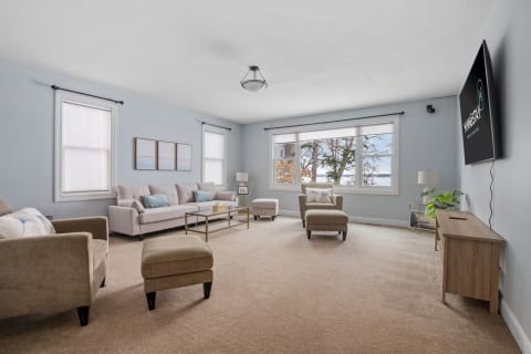 Bright living room with blue walls, a large couch, and modern decor.