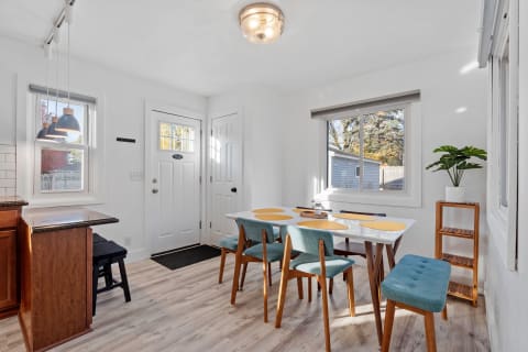 Bright dining area with wooden furniture and blue seating.