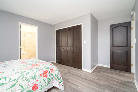 Interior view of a cozy bedroom with floral decor and wooden details.