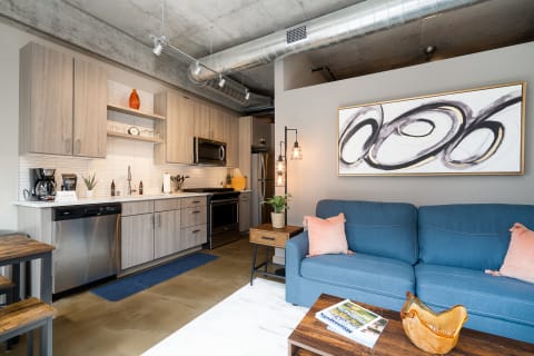 Interior of a modern apartment showcasing a kitchen and living area with contemporary decor.