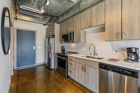 Contemporary kitchen featuring wood cabinets and stainless steel appliances.