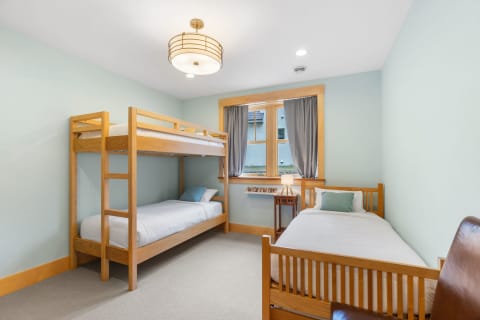 Cozy children's bedroom with a bunk bed and a single bed.