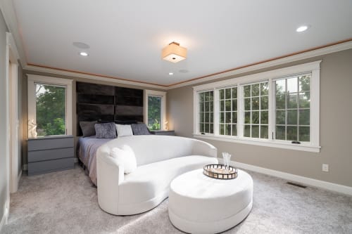 Unwind in your serene bedroom sanctuary with panoramic windows, cozy seating nook, and elegant modern touches for the perfect peaceful retreat.
