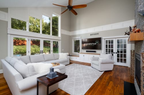 Sink into plush sectional seating while enjoying garden views through floor-to-ceiling windows in your bright, airy living space.