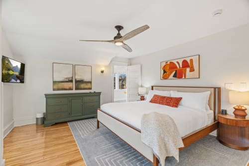 Unwind in your spacious bedroom featuring crisp linens, warm wood floors, and thoughtful artwork that creates the perfect retreat.