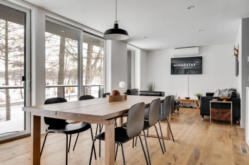 Settle into modern Nordic elegance with sleek dining space flowing into your living area, warmed by rich wood floors and natural light.