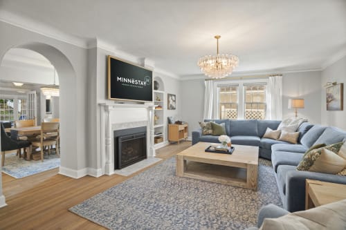 Sink into this plush sectional and feel the warmth of the fireplace as you unwind after your day of exploring. Sunlight fills the room, and thoughtful touches such as the distinctive chandelier make your stay feel truly special.