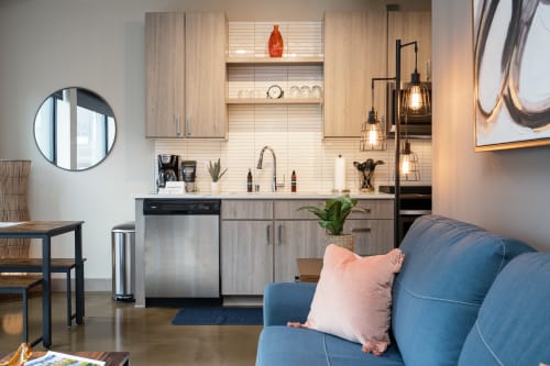 Your stylish open-plan living combines cozy seating with a fully-equipped kitchen, perfect for cooking meals and relaxing in modern comfort.