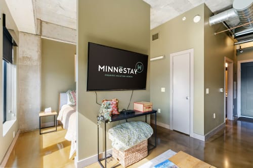 Unwind in your stylish living space with exposed concrete pillars and a large TV for movie nights.