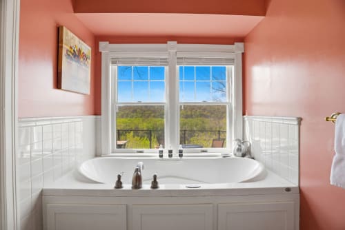 Soak in this serene bathtub while gazing at stunning natural landscape views through oversized windows—your perfect escape after a day of exploring.