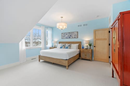 Drift off in your serene blue sanctuary, where soft lighting and peaceful garden views create the perfect retreat for restful nights.