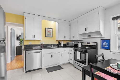 You'll love cooking in this bright, fully-equipped kitchen with cheerful yellow accents, granite countertops, and stainless steel appliances.